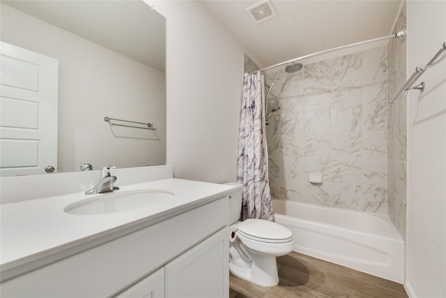 bathroom featuring vanity, shower / bathtub combination with curtain, wood finished floors, visible vents, and toilet