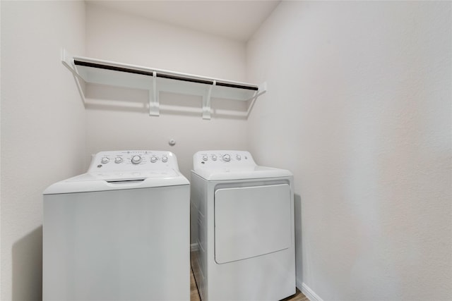 washroom featuring laundry area and washer and clothes dryer