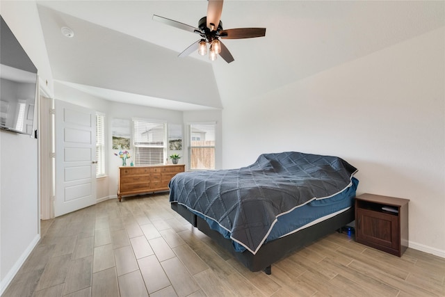 bedroom with wood finish floors, baseboards, lofted ceiling, and a ceiling fan