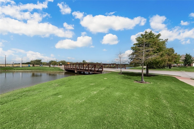 exterior space featuring a lawn and a water view