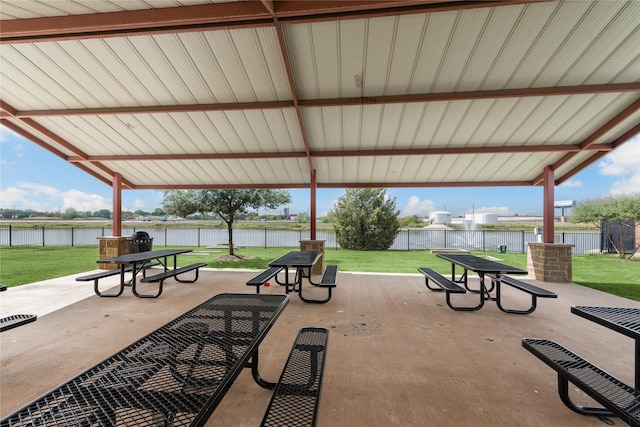 view of home's community featuring a yard, a patio, fence, and a water view