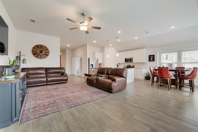 living room featuring visible vents, recessed lighting, a ceiling fan, and light wood-style floors