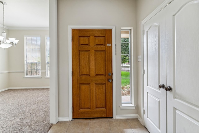 3104 Rim Rock Ct, Granbury, TX 76049 - foyer entrance with plenty of natural light, an inviting chandelier, light tile patterned flooring, and crown molding
