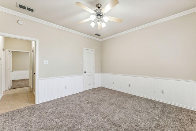 3104 Rim Rock Ct, Granbury, TX 76049 - empty room with visible vents, light colored carpet, ornamental molding, wainscoting, and a ceiling fan