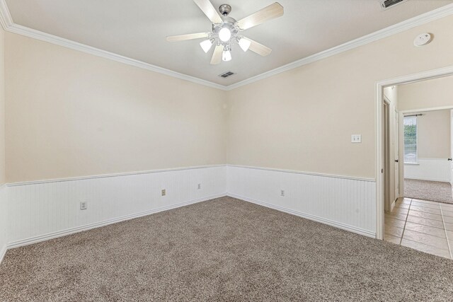 3104 Rim Rock Ct, Granbury, TX 76049 - spare room with light tile patterned floors, a ceiling fan, a wainscoted wall, and light carpet