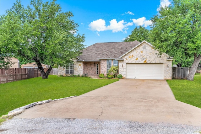 3104 Rim Rock Ct, Granbury, TX 76049 - view of front of property featuring a front yard, a garage, stone siding, and concrete driveway