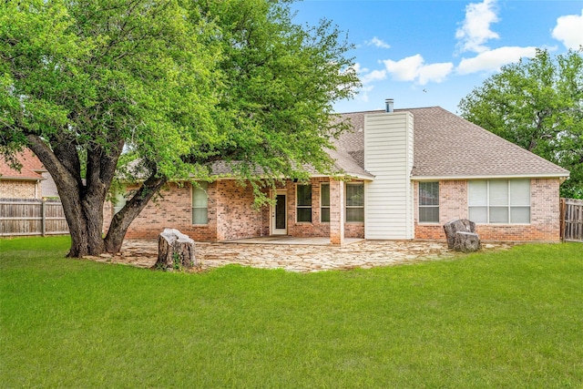 3104 Rim Rock Ct, Granbury, TX 76049 - rear view of property with a chimney, a patio area, fence private yard, a lawn, and brick siding