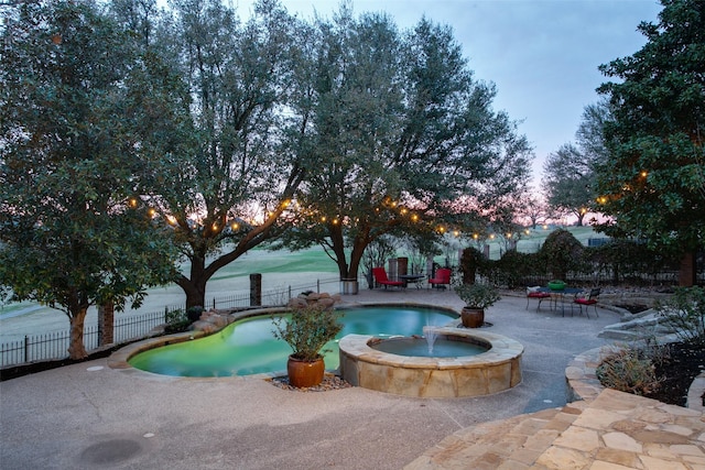 1630 Oak Ridge Dr, Corinth, TX 76210 - pool at dusk featuring a patio and a pool with connected hot tub