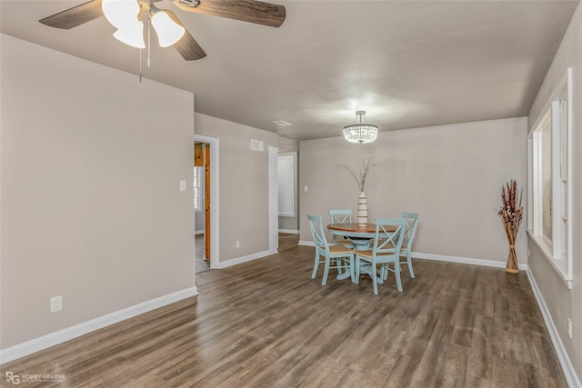 dining room featuring visible vents, ceiling fan with notable chandelier, baseboards, and wood finished floors