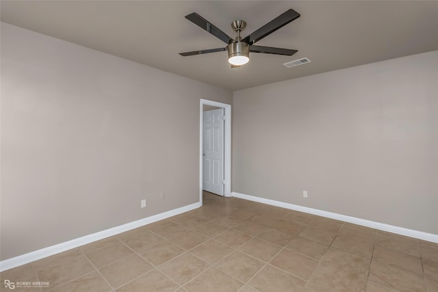 unfurnished room with light tile patterned floors, baseboards, visible vents, and ceiling fan