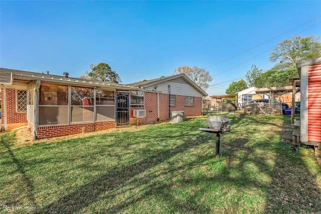 view of yard featuring cooling unit, fence, and a sunroom