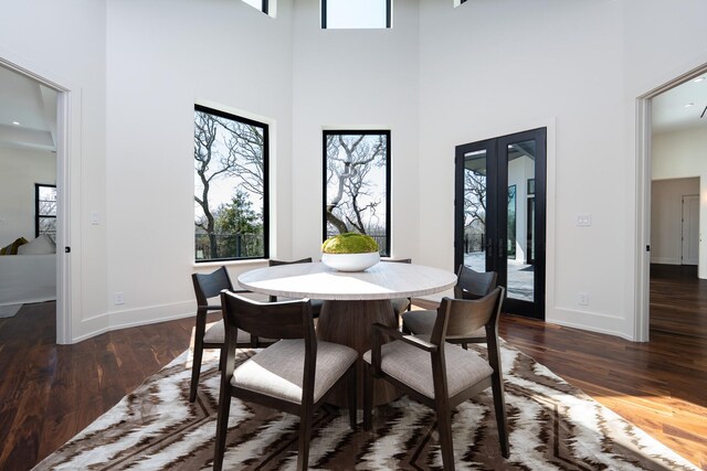 1230 Oak View Ct, Oak Point, TX 75068 - dining room with french doors, a high ceiling, dark wood-style floors, and baseboards