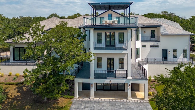 1230 Oak View Ct, Oak Point, TX 75068 - view of front of house with a balcony, stucco siding, and decorative driveway