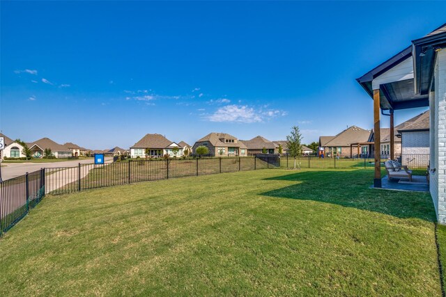 view of yard with a fenced backyard and a residential view