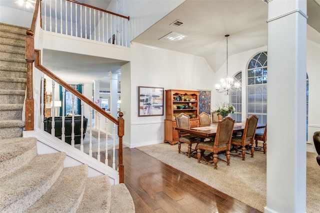 1500 Douglas Ave, Colleyville, TX 76034 - dining room with stairs, hardwood / wood-style floors, a chandelier, baseboards, and vaulted ceiling