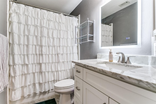 227 Moss Hill Rd, Irving, TX 75063 - full bathroom with a textured wall, vanity, and toilet