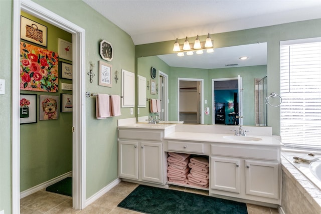 227 Moss Hill Rd, Irving, TX 75063 - full bathroom featuring double vanity, plenty of natural light, a bath, and tile patterned floors