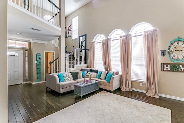 227 Moss Hill Rd, Irving, TX 75063 - living area with dark wood-type flooring, a towering ceiling, stairway, baseboards, and healthy amount of natural light