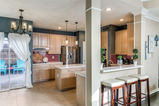 227 Moss Hill Rd, Irving, TX 75063 - kitchen with stainless steel fridge with ice dispenser, light countertops, decorative backsplash, under cabinet range hood, and light brown cabinetry