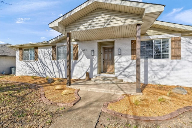 exterior space featuring brick siding