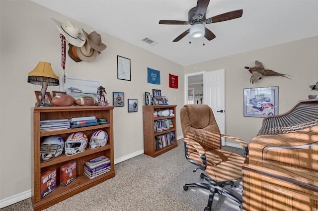 carpeted home office with visible vents, baseboards, and a ceiling fan
