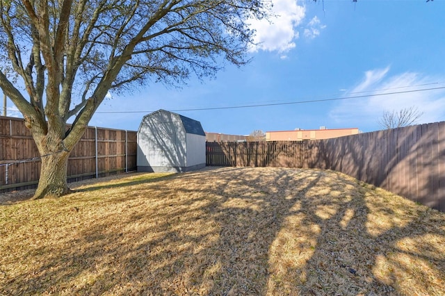 view of yard featuring a storage unit, a fenced backyard, and an outdoor structure