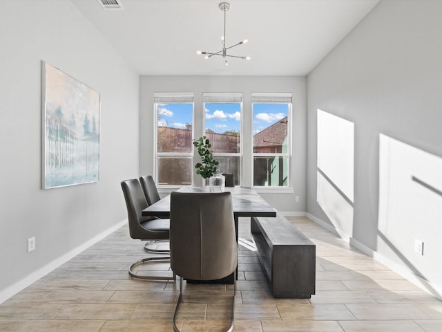 883 Alfred Ct, Allen, TX 75013 - dining area featuring a chandelier, wood finish floors, and baseboards