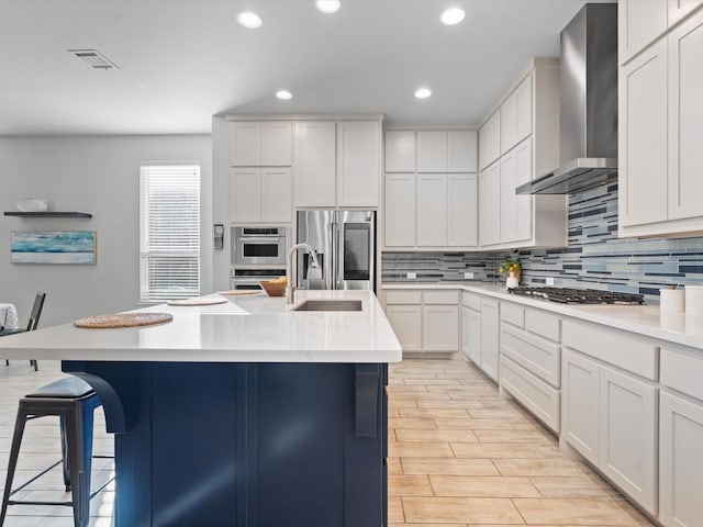 883 Alfred Ct, Allen, TX 75013 - kitchen featuring wall chimney range hood, stainless steel appliances, a kitchen breakfast bar, tasteful backsplash, and a sink