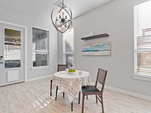 883 Alfred Ct, Allen, TX 75013 - dining area with a chandelier, healthy amount of natural light, wood finished floors, and baseboards