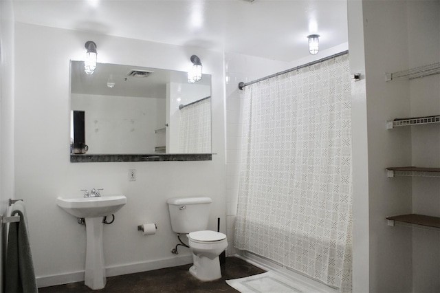 bathroom featuring baseboards, visible vents, and toilet