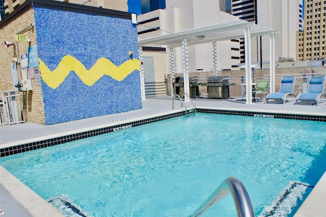 pool featuring fence, area for grilling, a pergola, and a patio area
