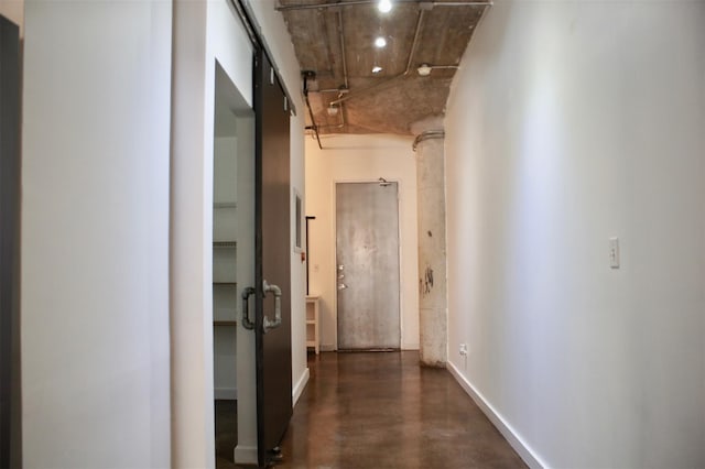 hall with concrete flooring