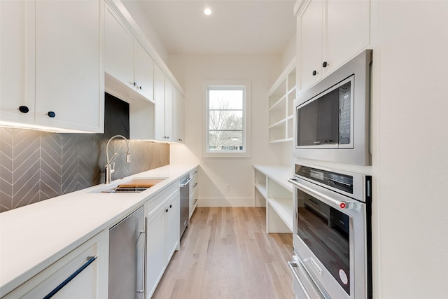 10519 Somerton Dr, Dallas, TX 75229 - kitchen featuring a sink, appliances with stainless steel finishes, decorative backsplash, and open shelves