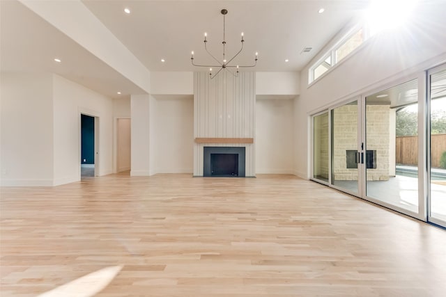 10519 Somerton Dr, Dallas, TX 75229 - unfurnished living room featuring recessed lighting, an inviting chandelier, a large fireplace, and light wood-type flooring