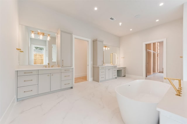 10519 Somerton Dr, Dallas, TX 75229 - bathroom with marble finish floor, recessed lighting, baseboards, visible vents, and a soaking tub