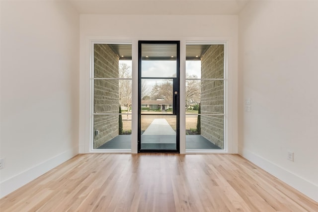 10519 Somerton Dr, Dallas, TX 75229 - entryway with baseboards and wood finished floors