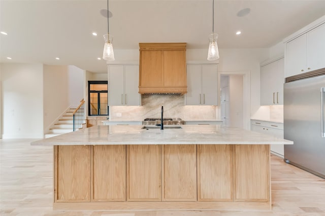 10519 Somerton Dr, Dallas, TX 75229 - kitchen featuring a spacious island, light wood-type flooring, recessed lighting, built in fridge, and tasteful backsplash