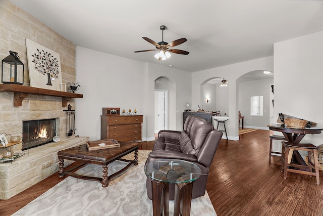 1229 Bridgeport Dr, Anna, TX 75409 - living area with arched walkways, ceiling fan, wood finished floors, and a fireplace