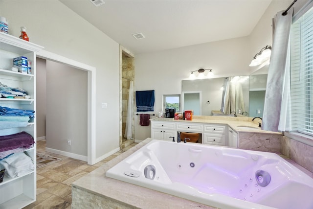 full bath featuring visible vents, a stall shower, a tub with jets, baseboards, and vanity