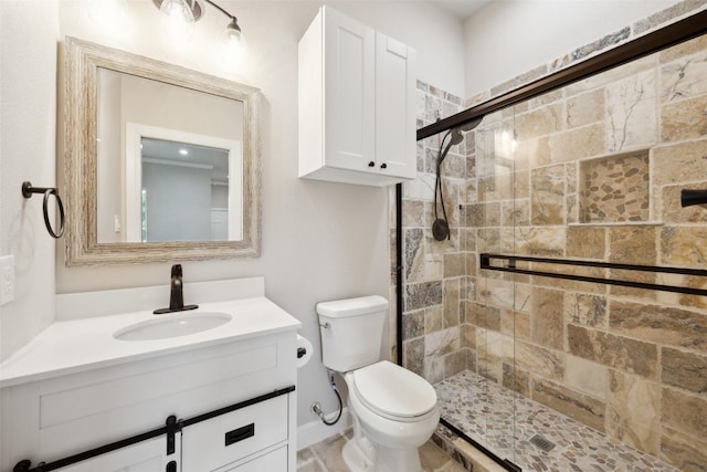 bathroom with toilet, a stall shower, and vanity