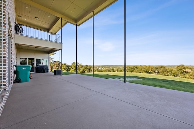 view of patio featuring a balcony