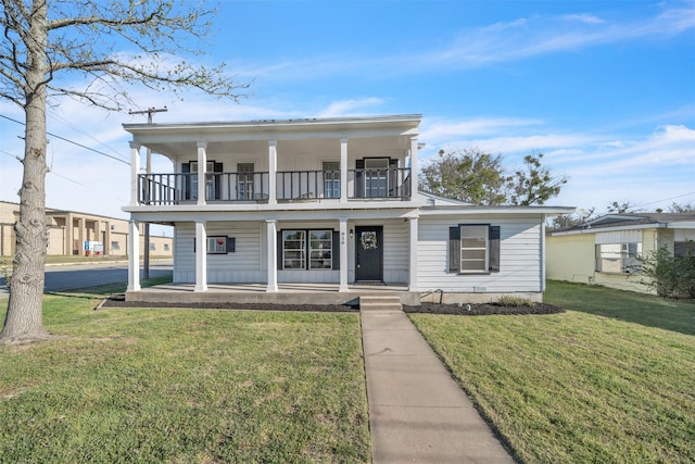 greek revival inspired property with a porch, a front yard, and a balcony