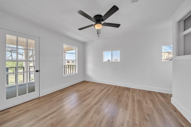 unfurnished room featuring ceiling fan, baseboards, and wood finished floors