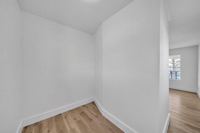 spare room with light wood-type flooring and baseboards