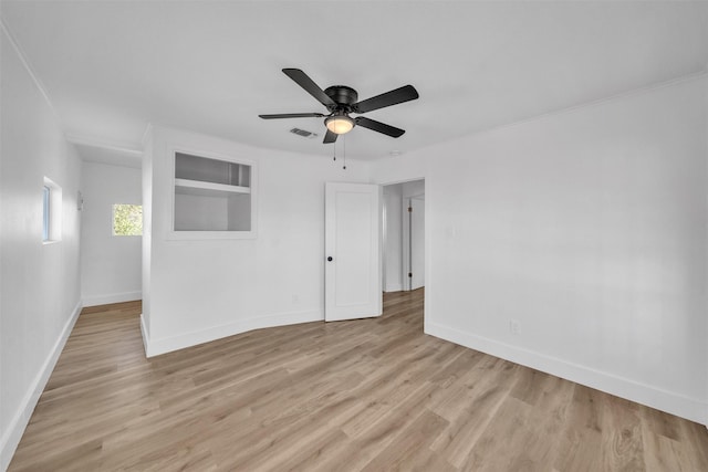 empty room with a ceiling fan, baseboards, visible vents, and light wood-type flooring