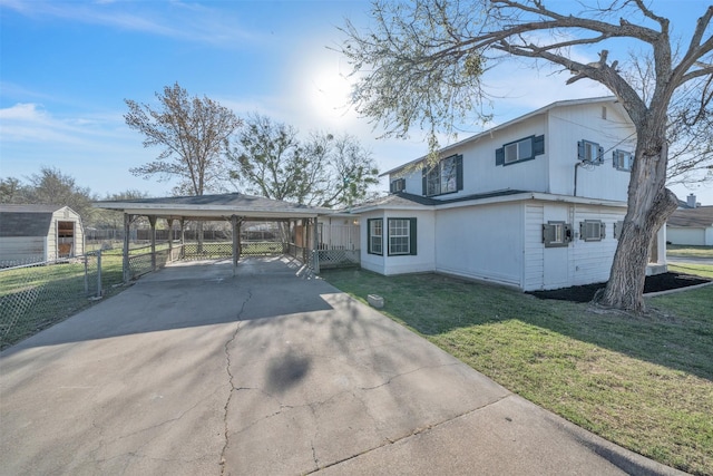 view of front of property with a carport, a front yard, driveway, and fence