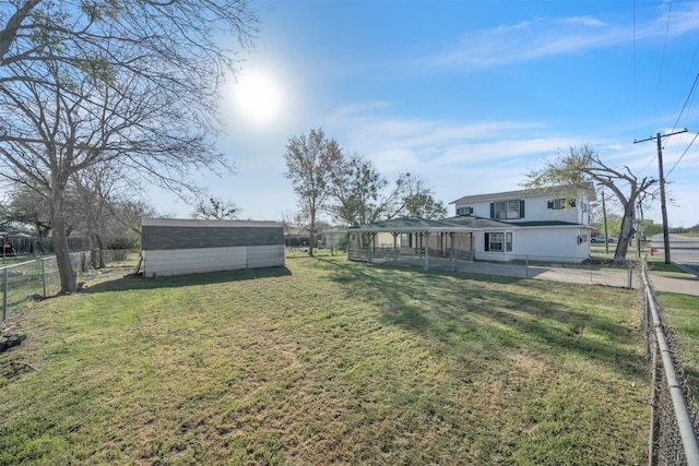 view of yard featuring an outdoor structure and a fenced backyard