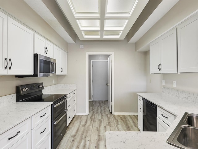 kitchen featuring double oven range, light wood finished floors, white cabinets, dishwasher, and stainless steel microwave