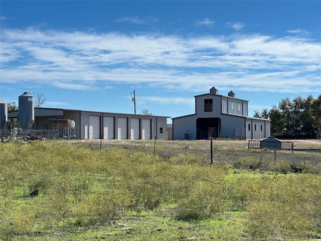 view of pole building featuring fence