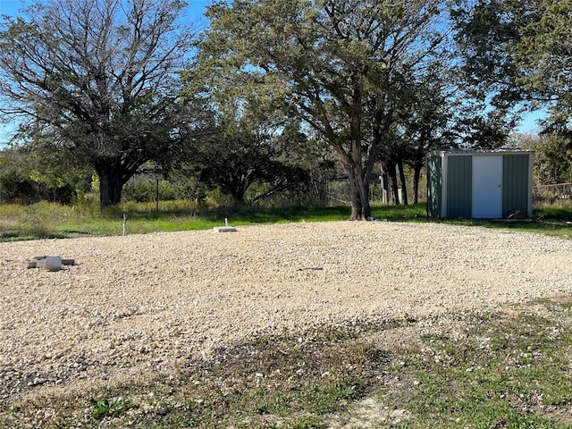 view of yard with a storage unit and an outbuilding